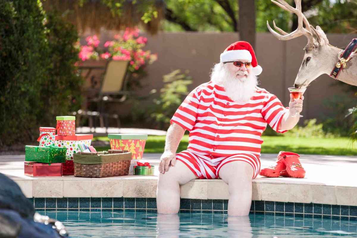 Santa sitting by a swimming pool during the holidays in Jacksonville & St. Augustine home