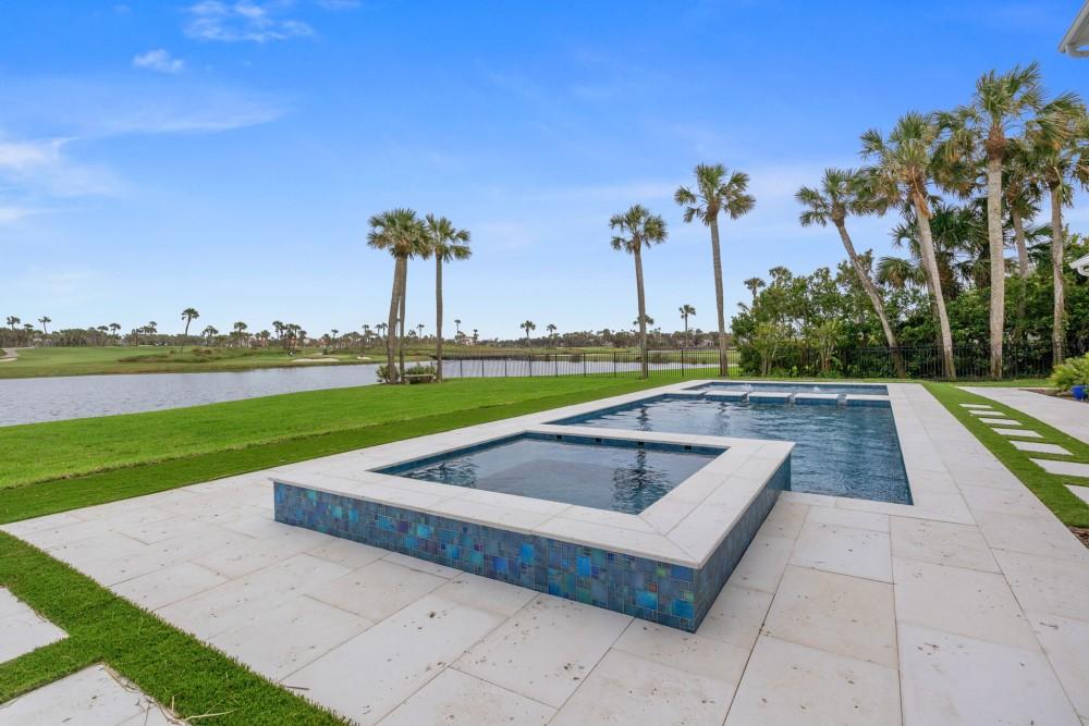 Backyard swimming pool with raised hot tub overlooking golf course in Southside Jacksonville, FL