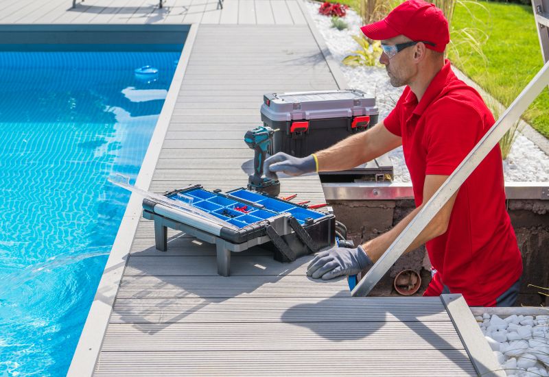A worker repairing pool infrastructure, showcasing professional pool maintenance in Jacksonville, FL