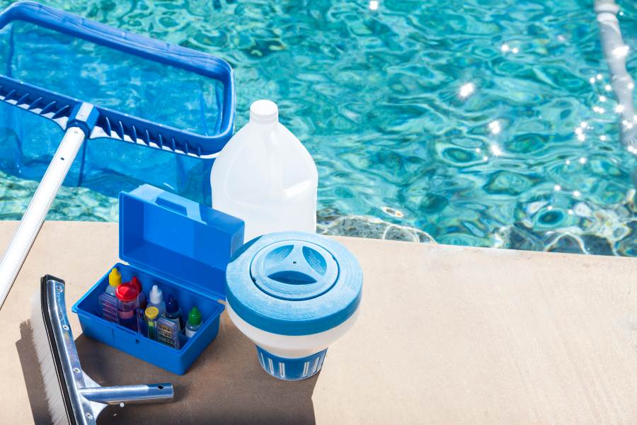 Pool maintenance worker cleaning a residential pool filter